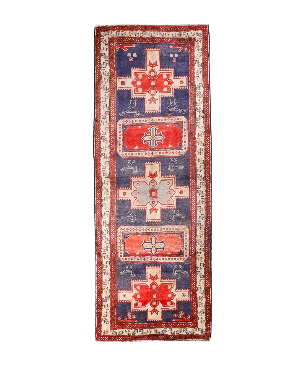 Persian runner rug with navy field, red border, and geometric medallion motifs.