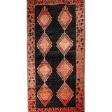 Persian Lori rug with black center and rust geometric diamond medallions