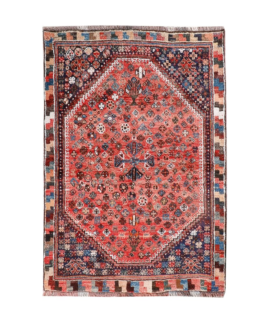 Persian-style rug with red medallion center, blue accents, and geometric border in dark tones