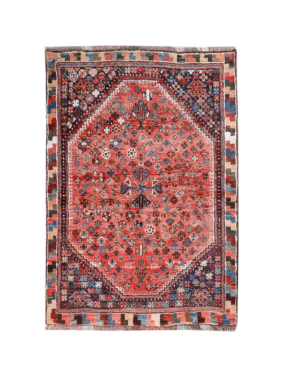 Persian-style rug with red medallion center, blue accents, and geometric border in dark tones