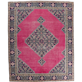 Persian Ardabil rug with pink field, navy border, and central geometric medallion