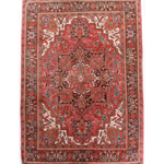 Persian Heriz rug with red medallion center, teal and cream details, ornate border.