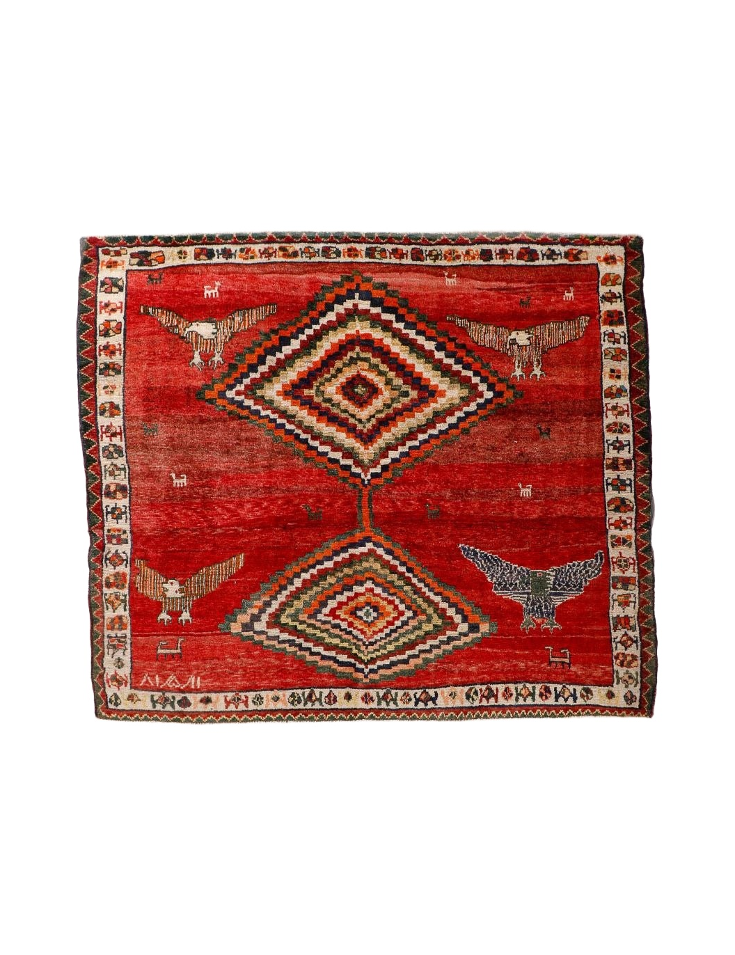 Red Persian-style rug with diamond medallion, birds, and multicolor border design.