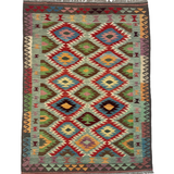 Rectangular kilim rug with repeating diamond medallions in red, teal, green, and yellow; fringed.