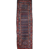 Navy blue runner rug with red and tan geometric borders, rectangular traditional pattern