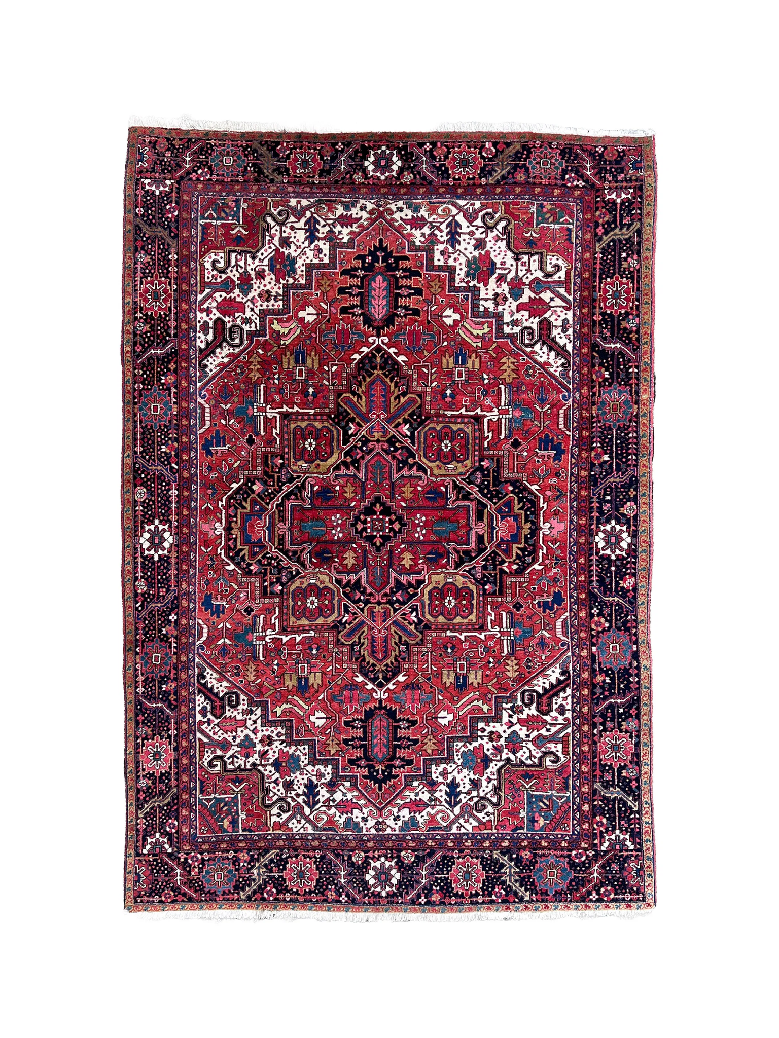 Persian Heriz rug with central crimson medallion, navy accents, and ornate border