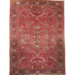 Red Persian-style Heriz rug with central medallion, ornate border, and cream accents