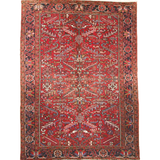 Red Persian-style Heriz rug with central medallion, ornate border, and cream accents