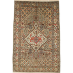 Oriental rug flat against white background, beige field with red center panel and blue accents