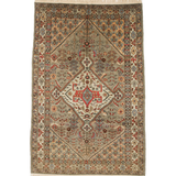 Oriental rug flat against white background, beige field with red center panel and blue accents