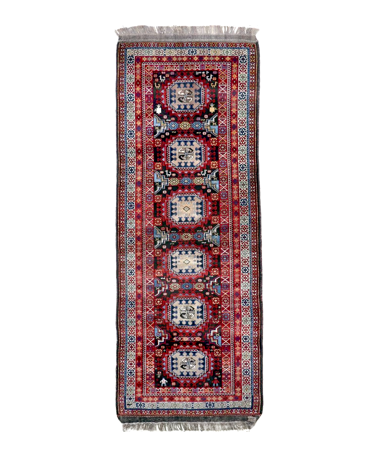 Semi-antique runner rug with red, blue and cream geometric medallion pattern