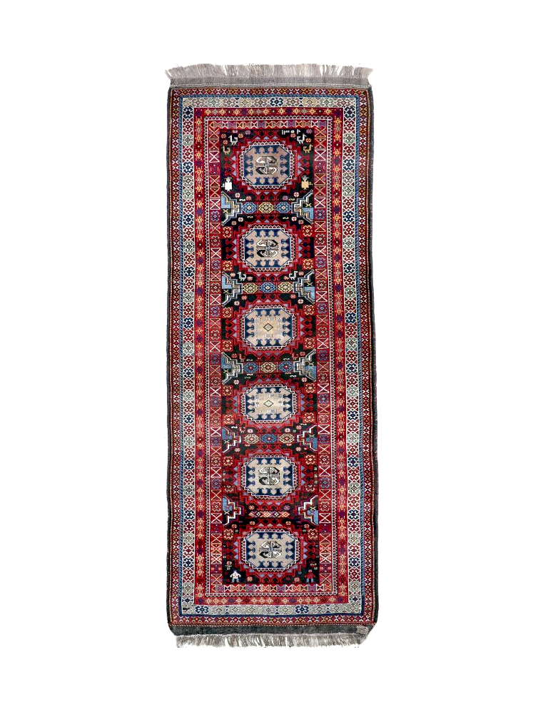 Semi-antique runner rug with red, blue and cream geometric medallion pattern
