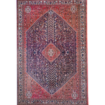 Full view Persian-style rug with red border, navy center, and diamond medallion