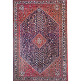 Full view Persian-style rug with red border, navy center, and diamond medallion