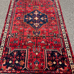 Vintage Tuyserkan Rug — Scarlet & Indigo Star Medallion. Additional original photograph showing the rug's surface, design and weave. SKU 52501024.