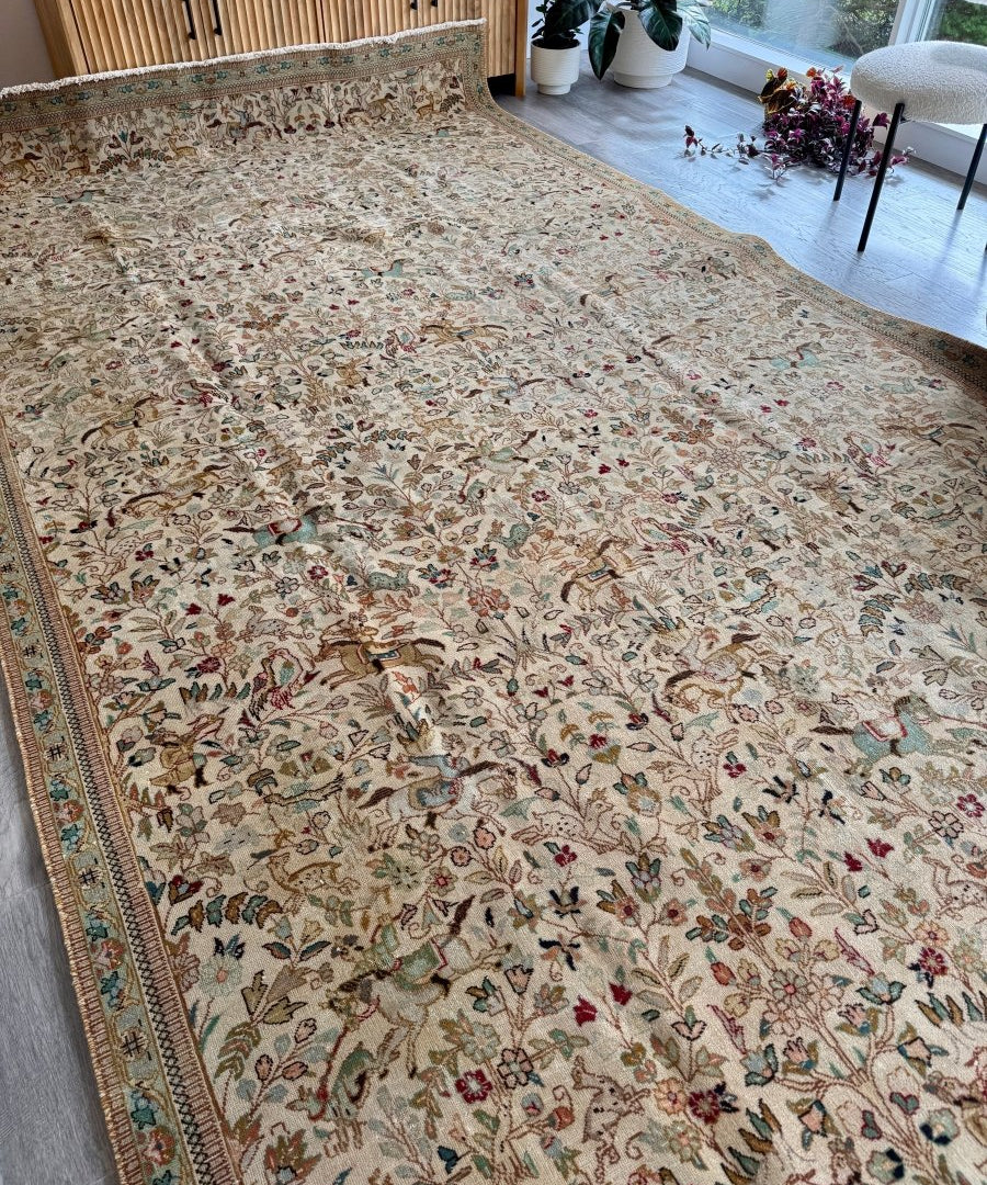 Tabriz Tabatabai rug on ivory ground with dense floral and vine border detail