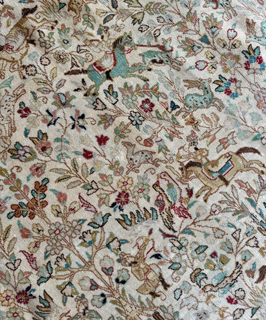 Tabriz Tabatabai rug with ivory floral sprigs and teal, red, and brown accents