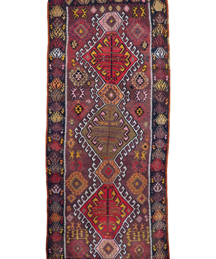 Kilim runner rug with tall geometric panel, red, navy, and yellow diamond motifs