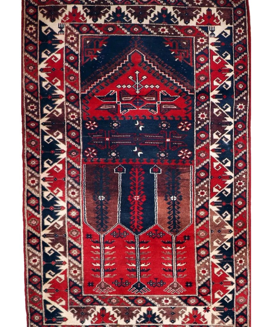 Turkish Konya rug front view on white background with red, navy, and cream geometric panels