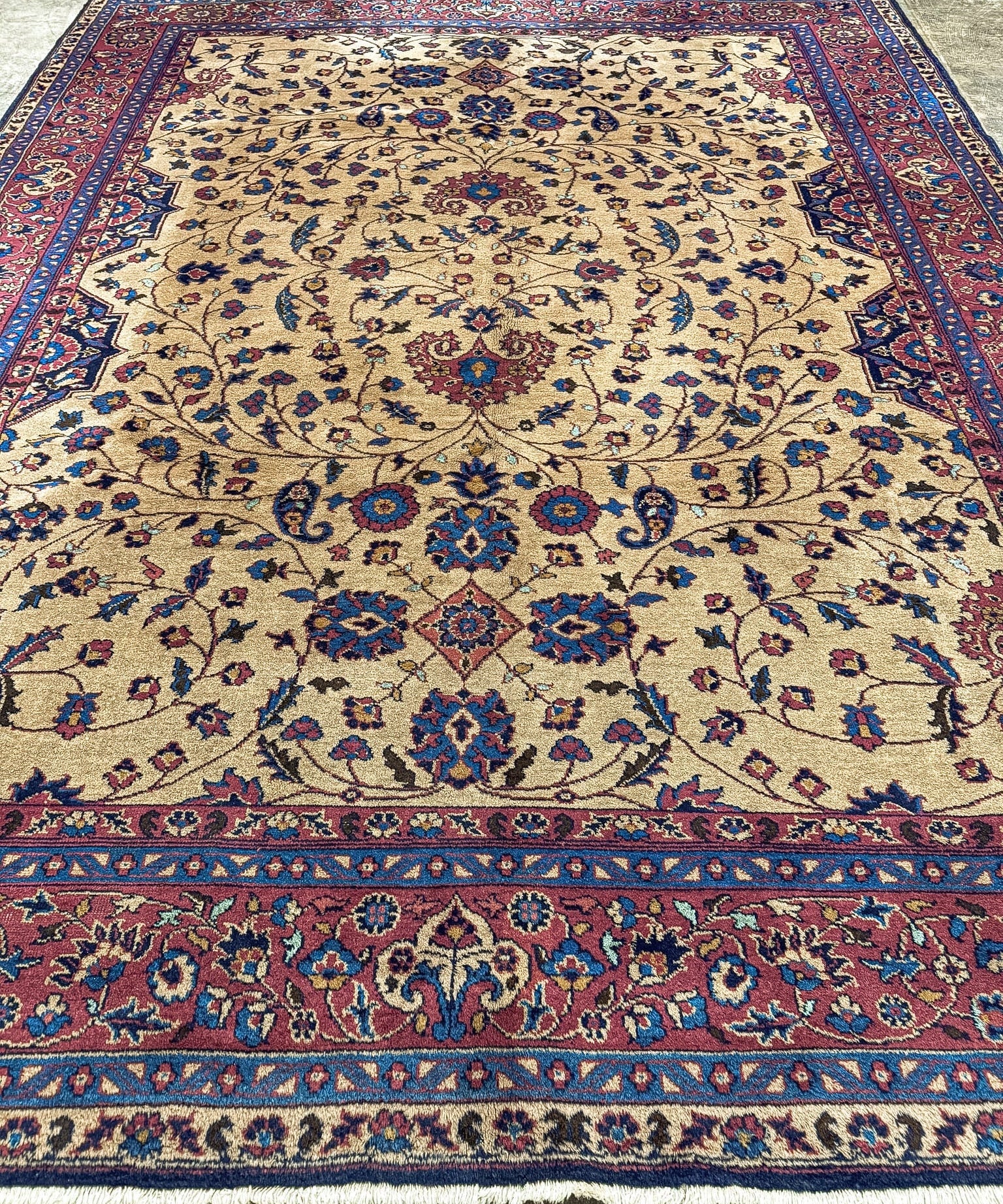 Turkish Oushak rug, wide view: cream background with navy and red floral vine pattern