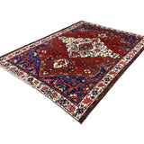 Vintage Chaleshtor Bakhtiari Rug, diagonal perspective view of the complete rug, hand-knotted wool pile. SKU 108870.