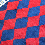 Red and blue diamond-check Gabbeh rug with white border detail