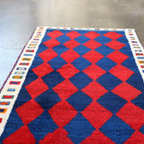 Vintage Persian Gabbeh rug in red and navy with cream border and diamond grid