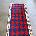 Vintage Persian Gabbeh rug with repeating red-and-navy diamonds and cream border