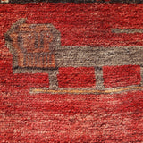 Persian Gabbeh rug detail showing cream and dark animal-like motif on red field.