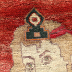 Close-up portrait motif on a red Persian Gabbeh rug with cream figure and dark accents.