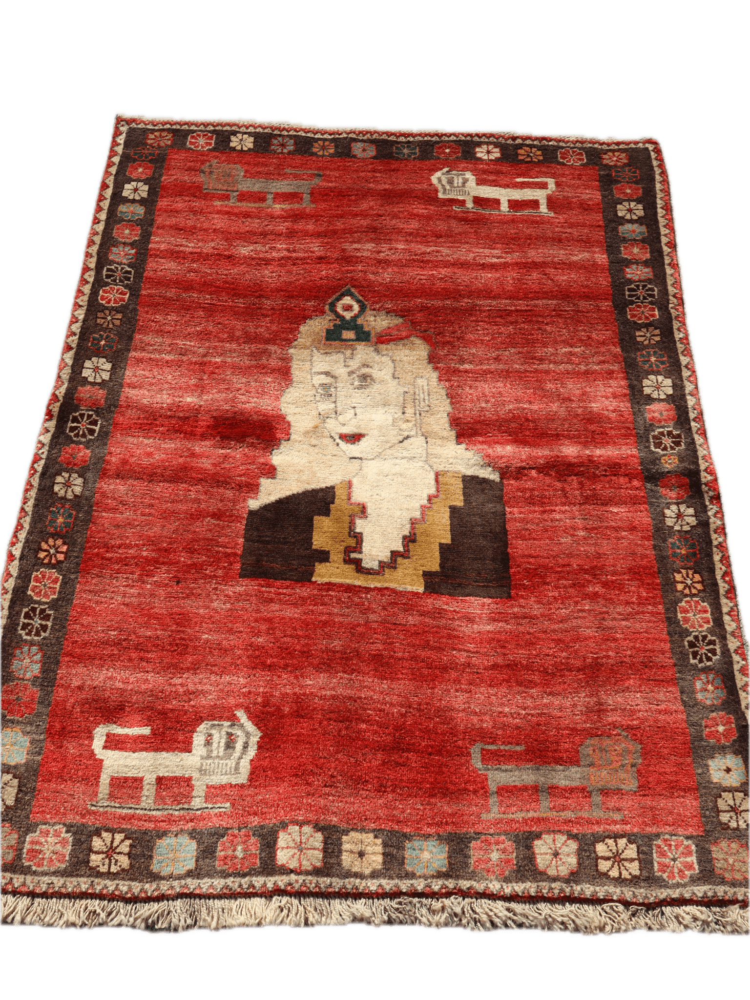 Full view vintage Persian Gabbeh rug with red field, cream portrait, and dark floral border.