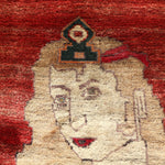 Gabbeh rug close-up showing a cream animal figure on a red background with dark accents