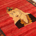 Persian Gabbeh rug close-up of cream portrait with red background and dark corner border.