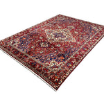 Vintage Saman Bakhtiari Rug, angled view showing the full field and borders, hand-knotted wool pile. SKU EE 1.1233.