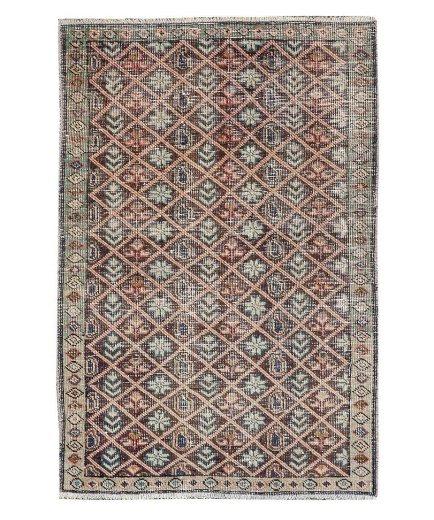 Vintage geometric rug with red-brown and teal diamonds on a light beige background