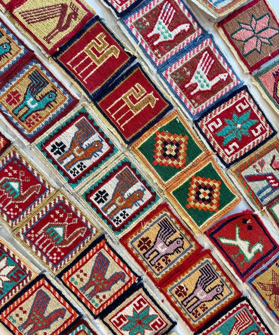 Wool kilim coasters arranged diagonally with multicolor geometric pattern squares