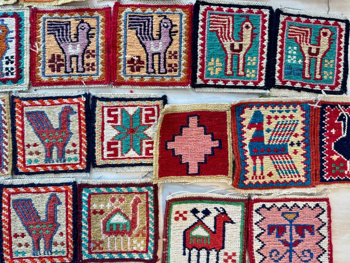 Wool kilim coaster grid with small pictorial motifs in red, blue, green, and cream