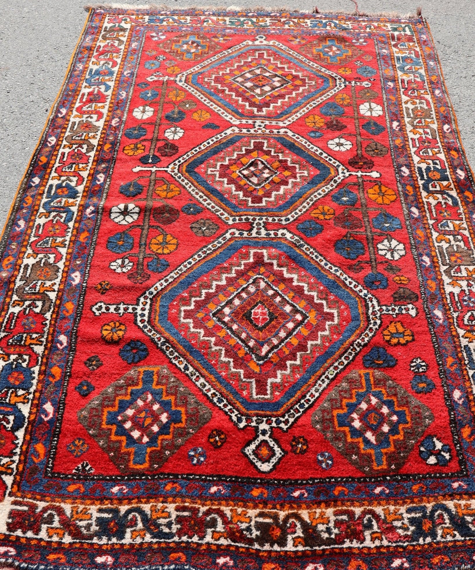 Qashqai rug, red ground with central diamond medallion and multicolor geometric pattern
