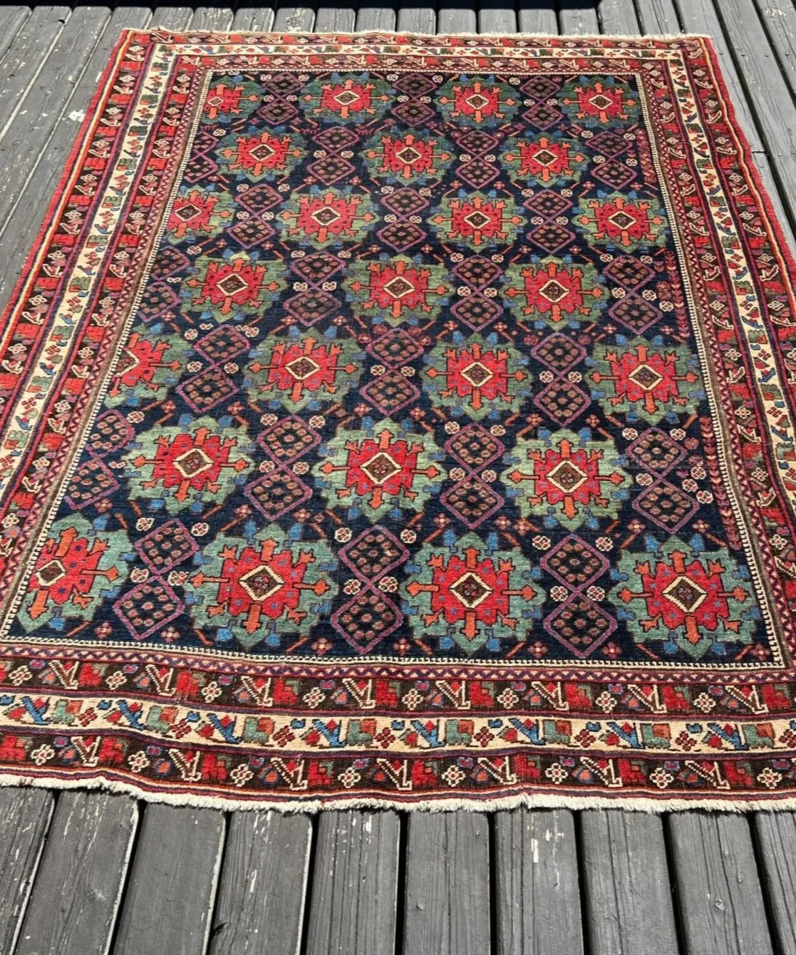 Antique Afshar rug with dark blue field, red and green geometric motifs, wide red border