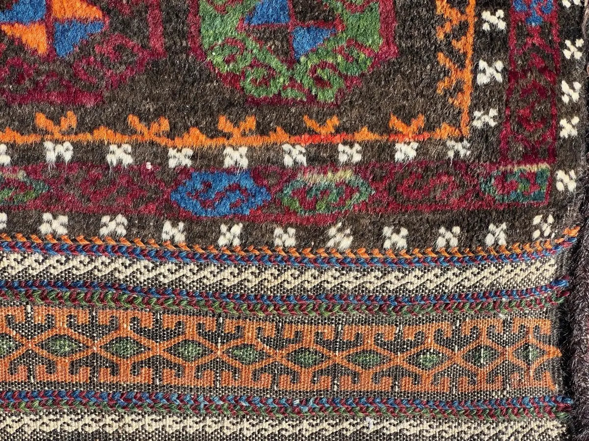 Baluch saddlebag rug close-up of multicolor geometric border and trim