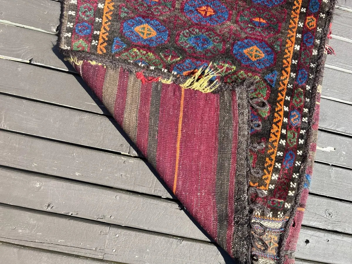 Baluch saddlebag side panel with vertical stripes and decorative trim