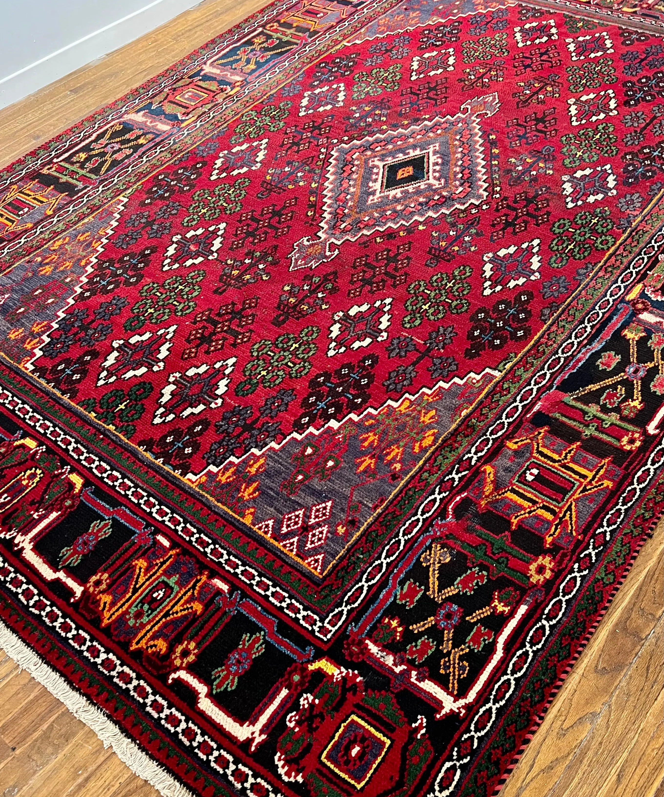 Persian Joshaqan rug with red field, diamond medallion, and multicolor floral patterns