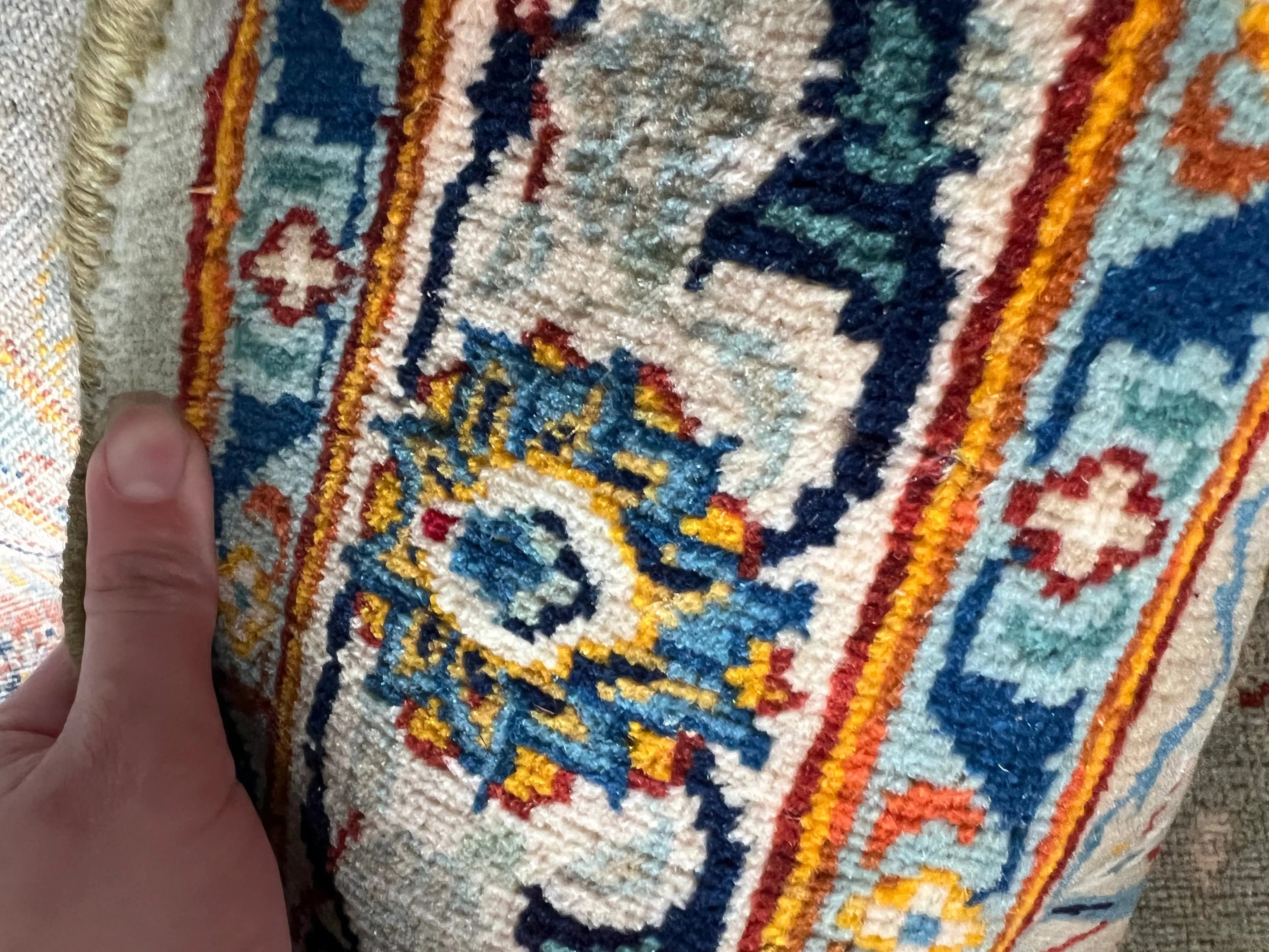 Persian Kashan rug corner detail, blue medallions with orange-red and navy stripes
