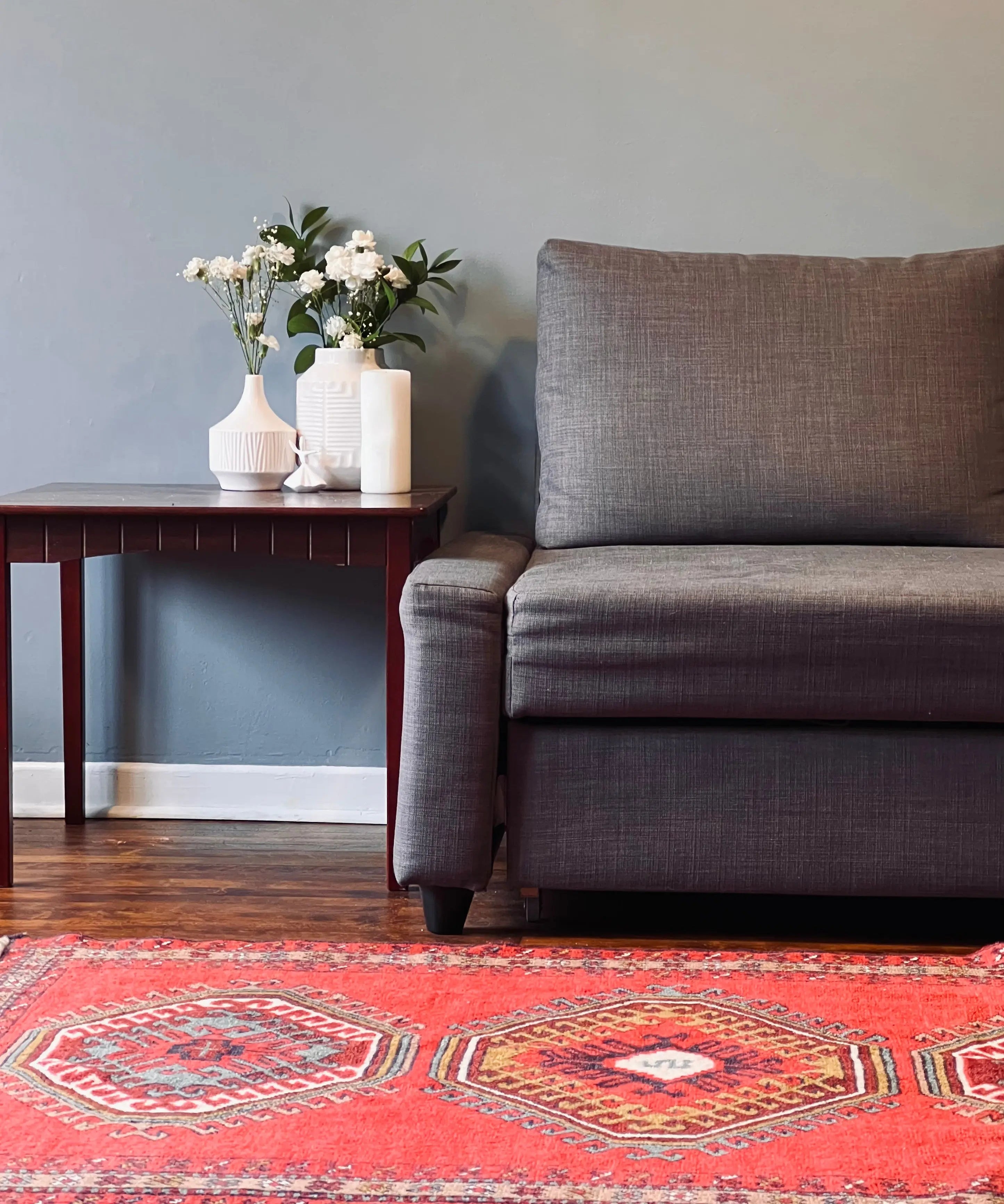 Red rug with geometric motifs and border, multicolor accents, short fringe edges