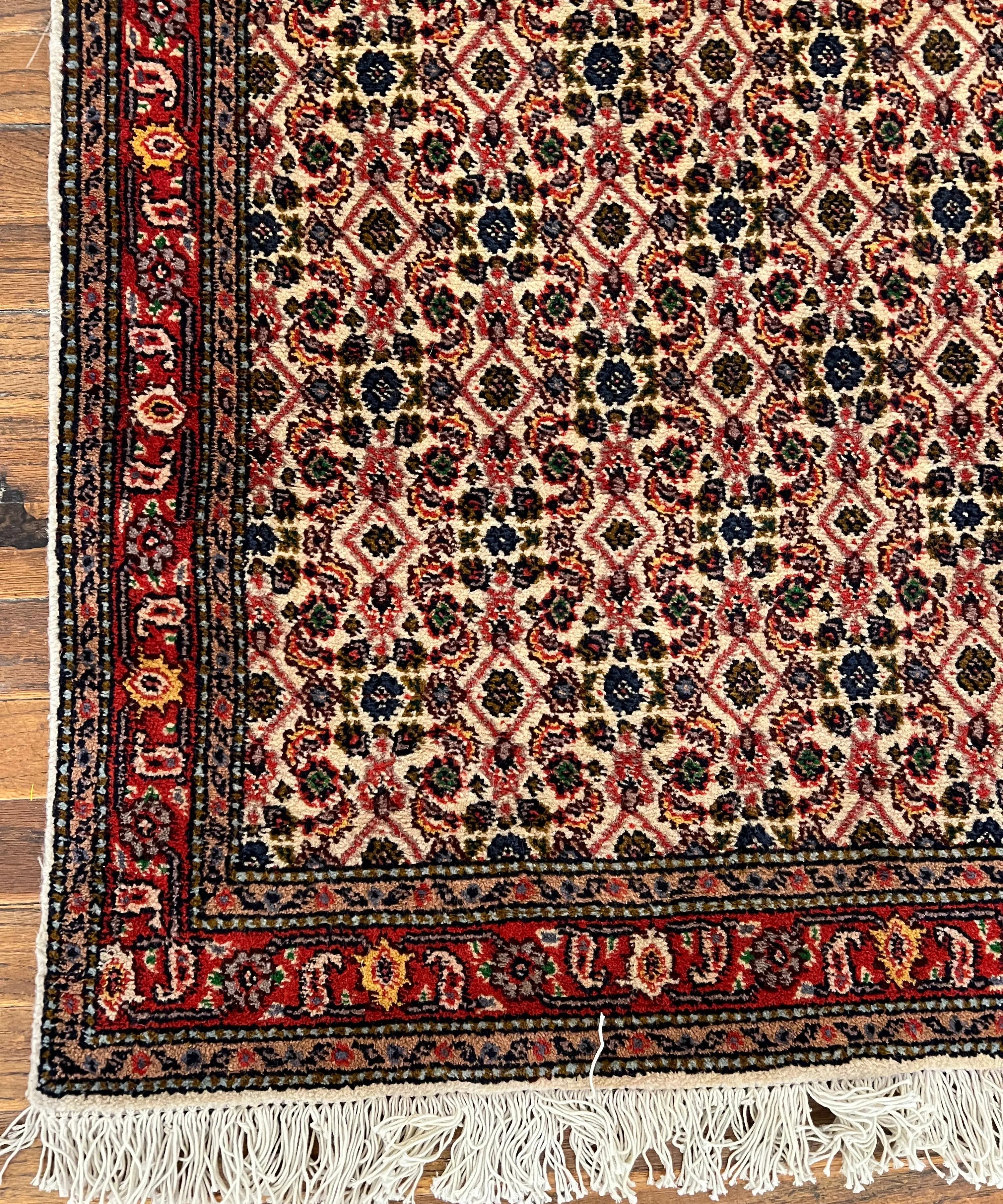 Runner rug bottom border with red field, navy accents, and cream fringe