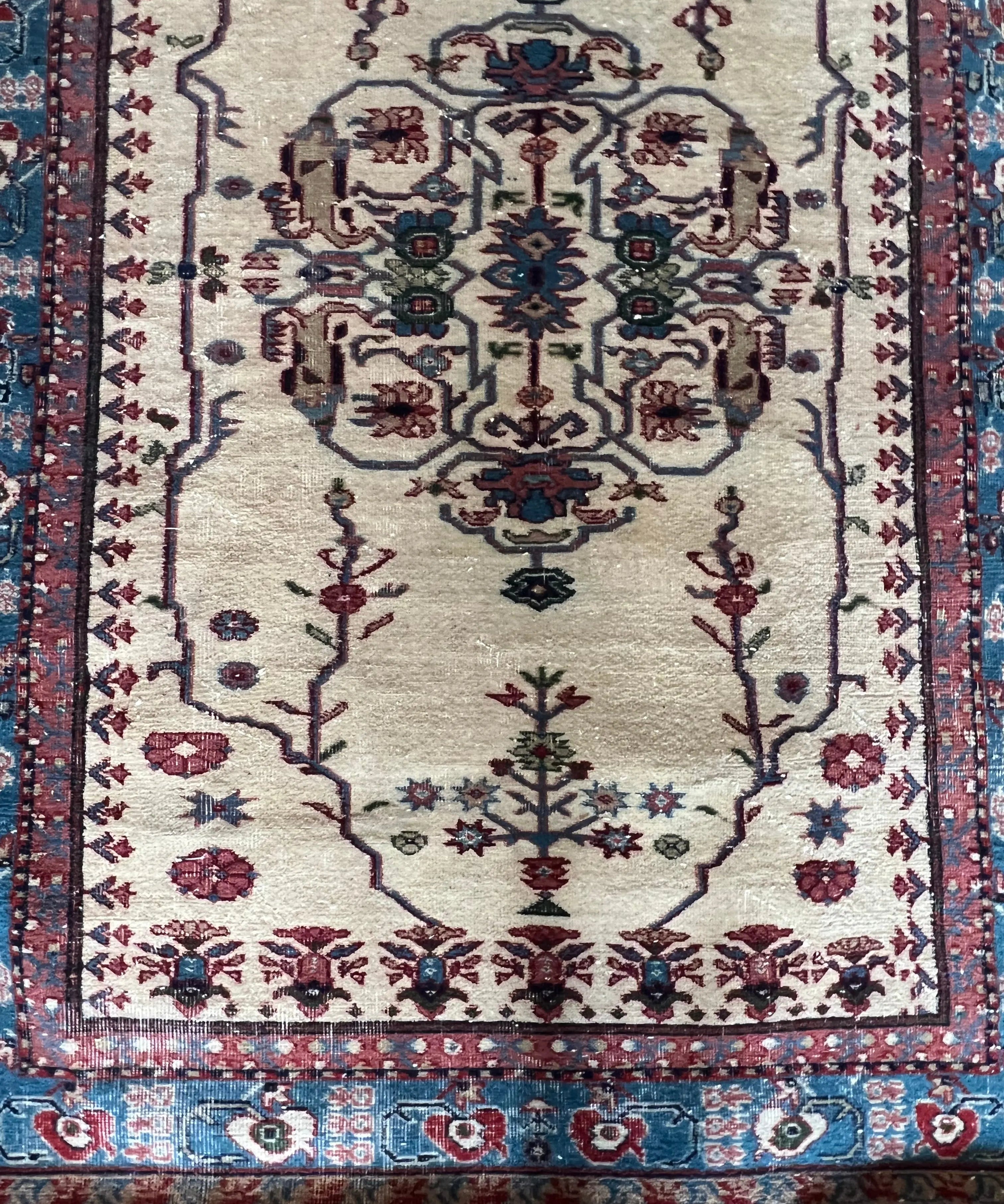 Turkish Isparta rug with cream field, blue and burgundy medallion and vine border