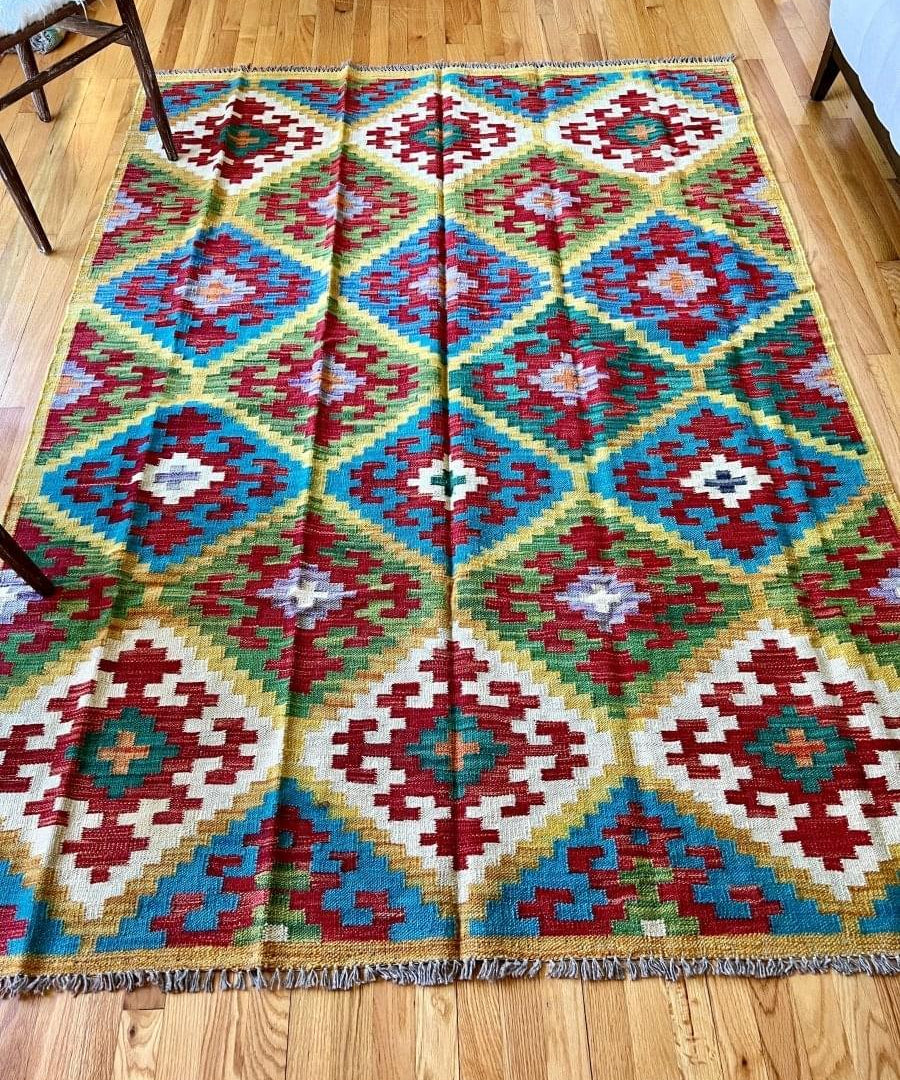 Kilim rug flat view with geometric diamond pattern in teal, green, red, white