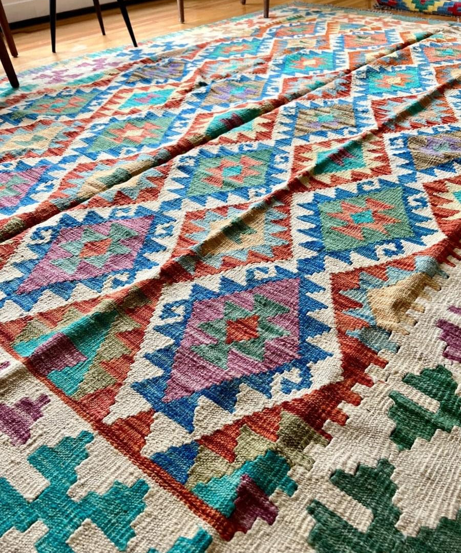 Kilim rug with bold blue stripe border and colorful diamond pattern