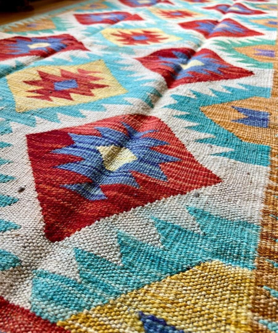 Woven kilim runner rug with large colorful diamond blocks and zigzag borders