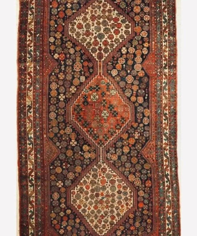 Antique Khamseh rug with dark red, navy and cream medallion pattern, bordered edges